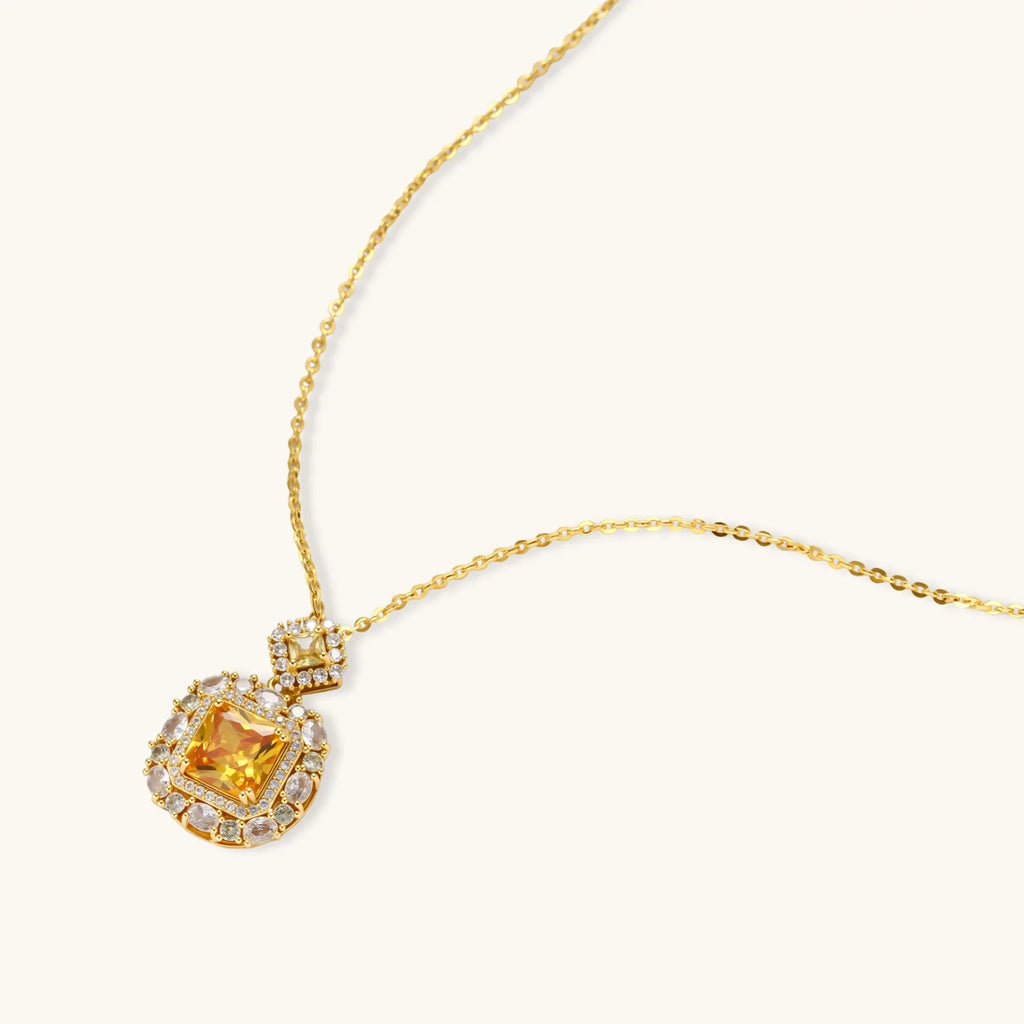 14K gold-plated jewelry set featuring square-cut cubic zirconia stones in ornate layered settings on white background.